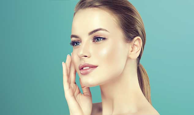 Morpheus8 skin remodelling Amsterdam - woman in profile touching her cheek with one hand Woman in profile touching her cheek with one hand against a teal background for Morpheus8 skin remodelling in Amsterdam